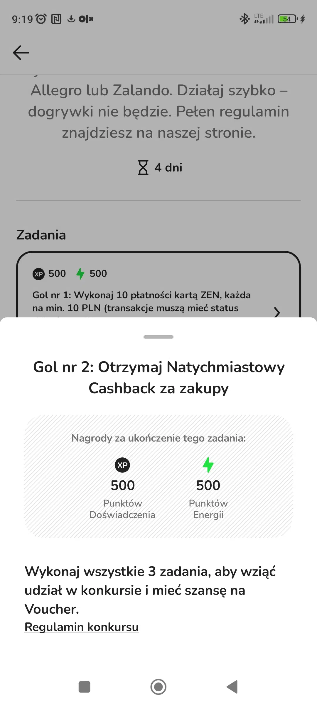 Zrzut ekranu z aplikacji ZEN.COM przedstawiający drugie zadanie w konkursie „Strzel hat-tricka z Messim”. Zadanie polega na otrzymaniu Natychmiastowego Cashbacku za zakupy. Na ekranie widoczne są także nagrody za ukończenie zadania — 500 punktów doświadczenia oraz 500 punktów energii — a poniżej informacja o konieczności wykonania wszystkich 3 zadań, aby wziąć udział w konkursie i zdobyć voucher do Allegro lub Zalando.