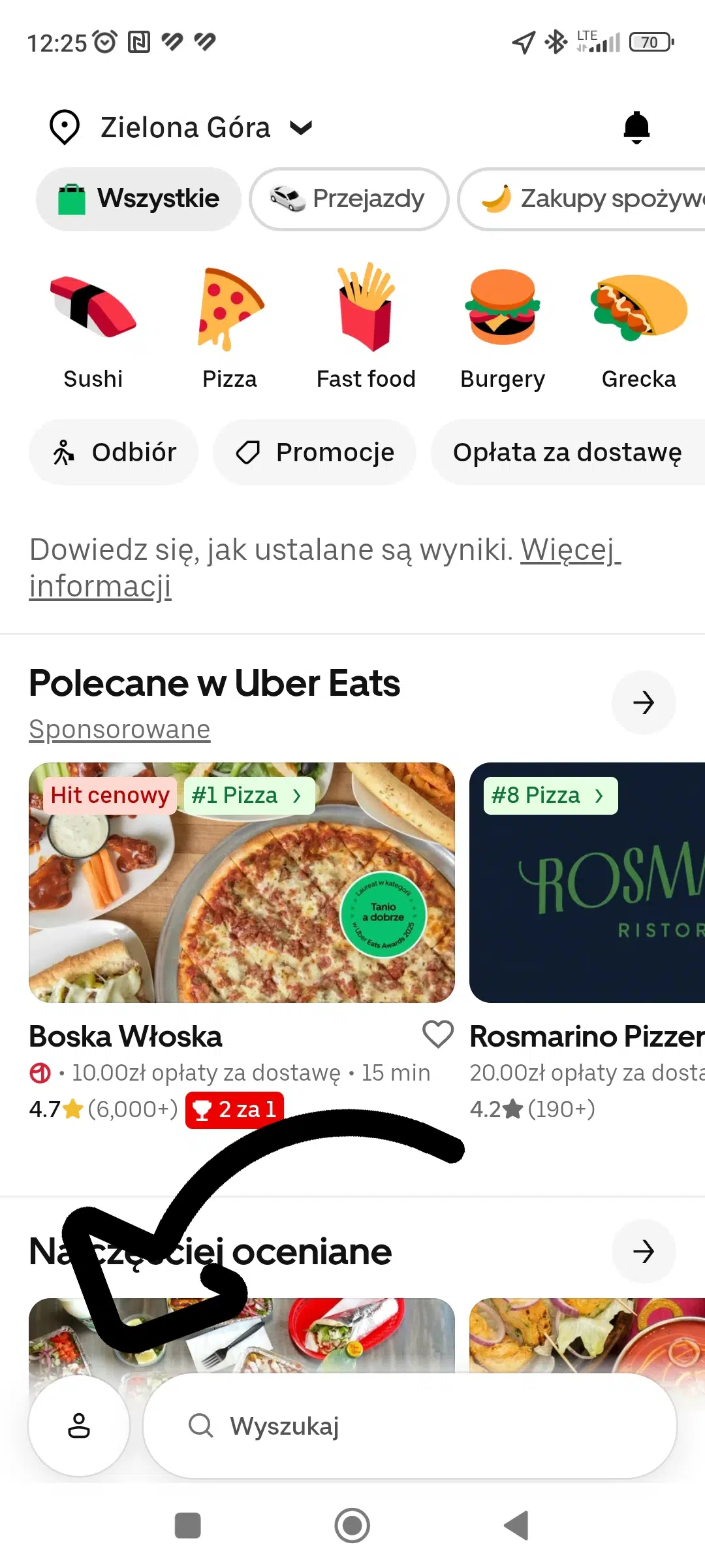 Mobilny widok aplikacji Uber Eats z ekranem głównym i zaznaczoną ikoną profilu, od której można przejść do ustawień konta i sekcji z promocjami oraz kodami rabatowymi.